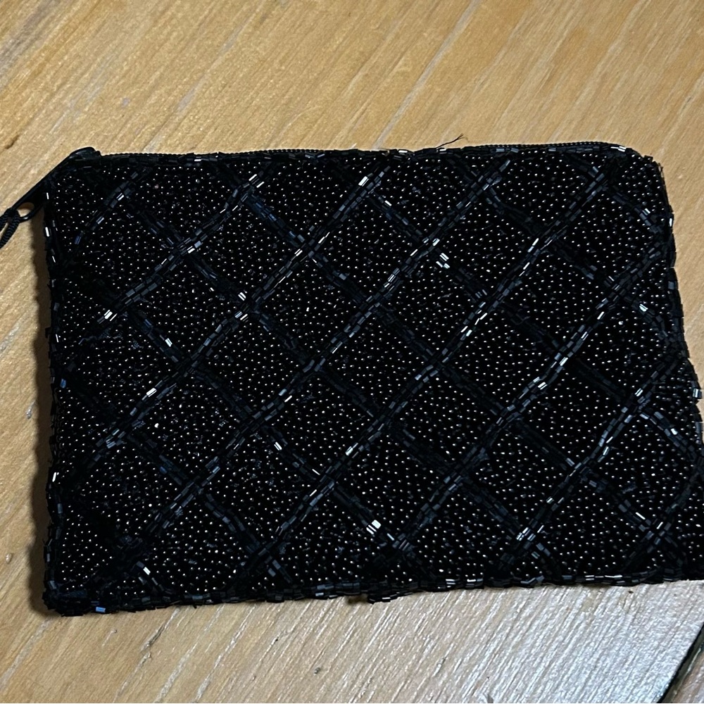 Black beaded clutch with zipper and tassel. 6” x 4.25”